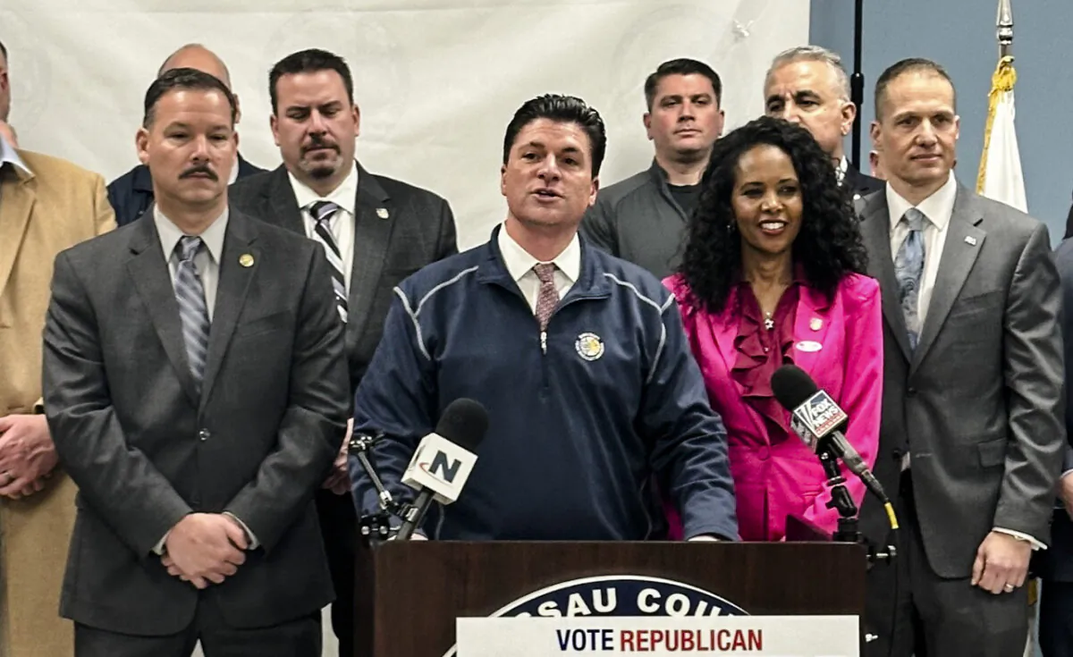 Mazi Pilip with law enforcement supporters at Nassau County PBA office in Mineola, N.Y., on Feb. 9, 2024. At the podium speaking is Nassau County PBA President Tommy Shevlin. (Juliette Fairley/The Epoch Times)