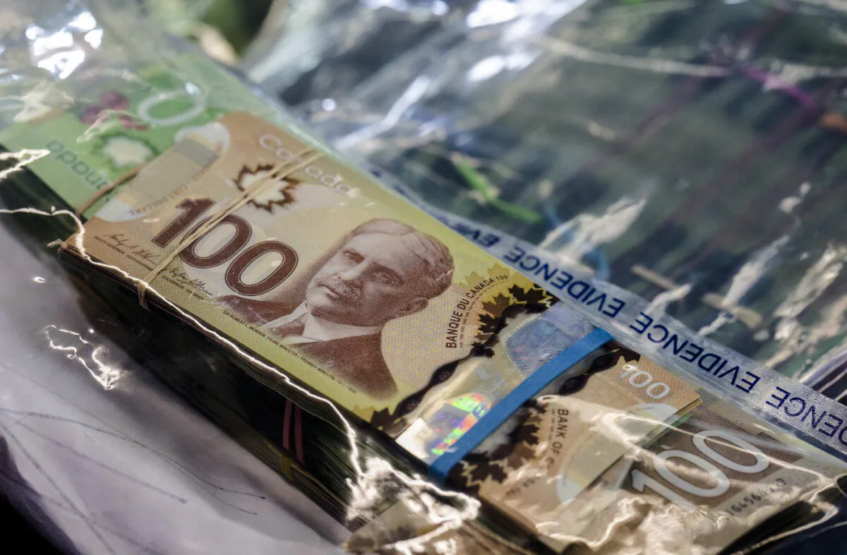 Cash seized by police during a bust is displayed at RCMP headquarters In Surrey, B.C., on Dec. 7, 2022. (The Canadian Press/Jonathan Hayward)