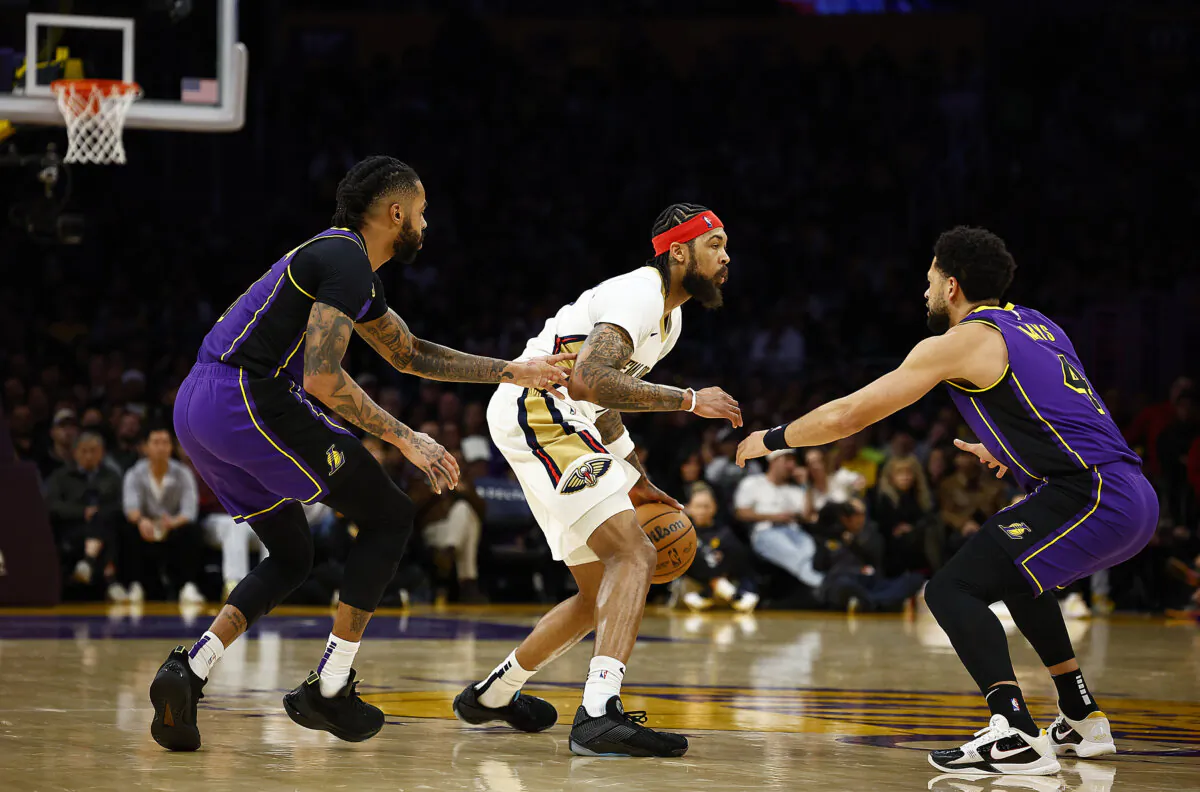 Brandon Ingram (14) of the New Orleans Pelicans is guarded by D'Angelo Russell (L) of the Los Angeles Lakers in the second half in Los Angeles on Feb. 9, 2024. (Ronald Martinez/Getty Images)
