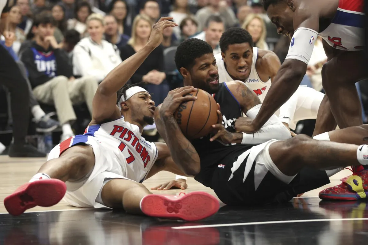 Los Angeles Clippers forward Paul George, center, vies for a loose ball with Detroit Pistons guard Stanley Umude during the first half of an NBA basketball game in Los Angeles on Feb. 10, 2024. (Raul Romero Jr./AP Photo)