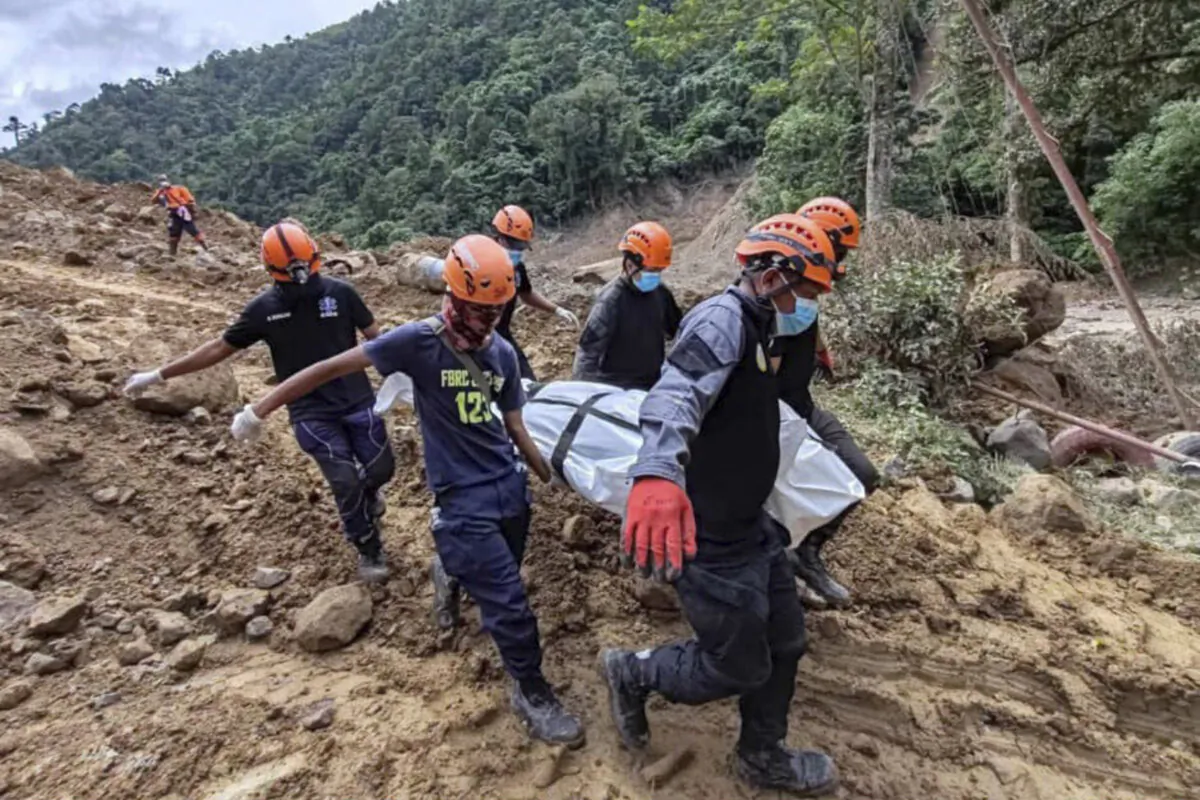 Rescuers carry a body they recovered at the landslide-hit village of Maco in Davao de Oro province, southern Philippines, on Feb. 9, 2024. (Municipality of Monkayo via AP)