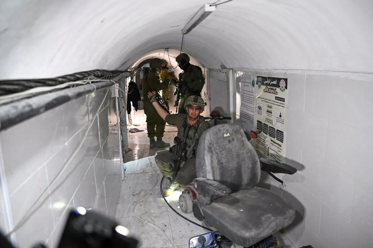 An Israeli soldier gestures in what the military described as a Hamas command tunnel running partly under the U.N. Relief and Works Agency's headquarters in the Gaza Strip on Feb. 8, 2024. (Dylan Martinez/Reuters)
