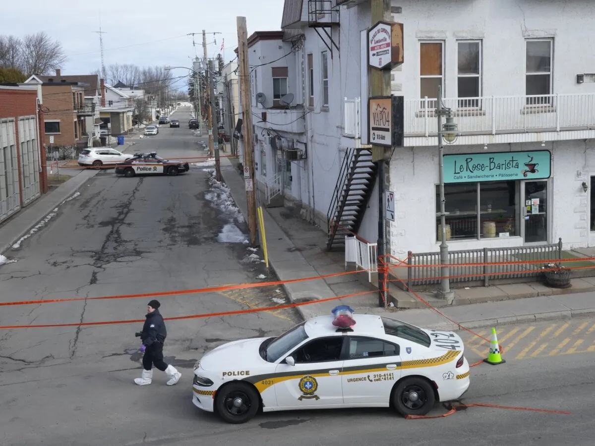 Police tape cordons off the scene after a Quebec provincial police officer was killed while trying to arrest a man in Louiseville, Que., on March 28, 2023. (The Canadian Press/Ryan Remiorz)