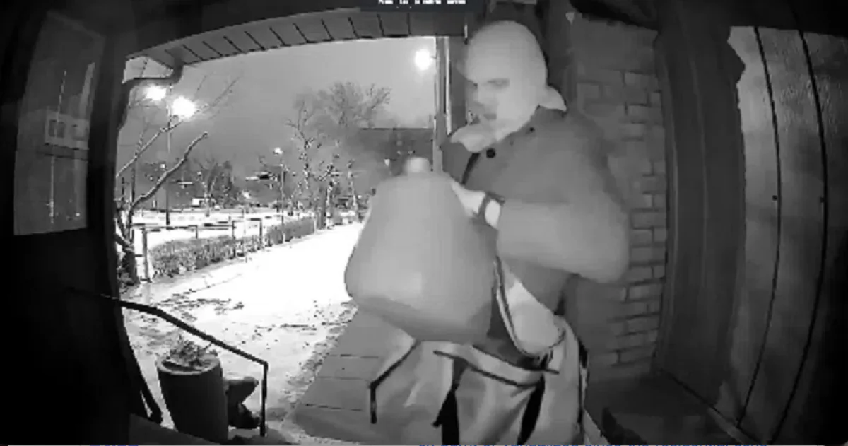 A still from surveillance footage shared on social media shows a suspect appearing to start a fire at the office entrance of Regina’s Blessed Sacrament Parish on Feb. 9, 2024. (Screenshot via The Epoch Times)