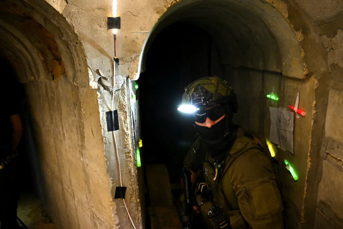 An Israeli soldier stands in what the military described as a Hamas command tunnel running partly under UNRWA headquarters in the Gaza Strip on Feb. 8, 2024. (Dylan Martinez/Reuters)