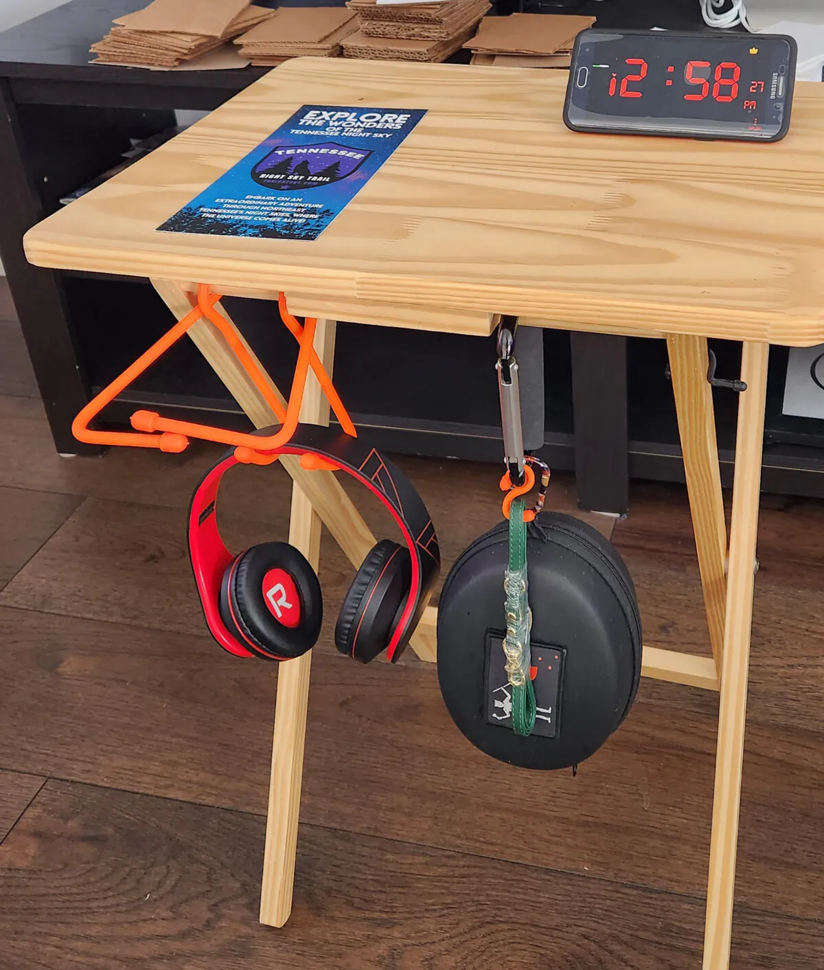 Tactical gear ties of different sizes are bent into shape and affixed to a tray table to keep items handy in a mobile office. (Myscha Theriault/TNS)