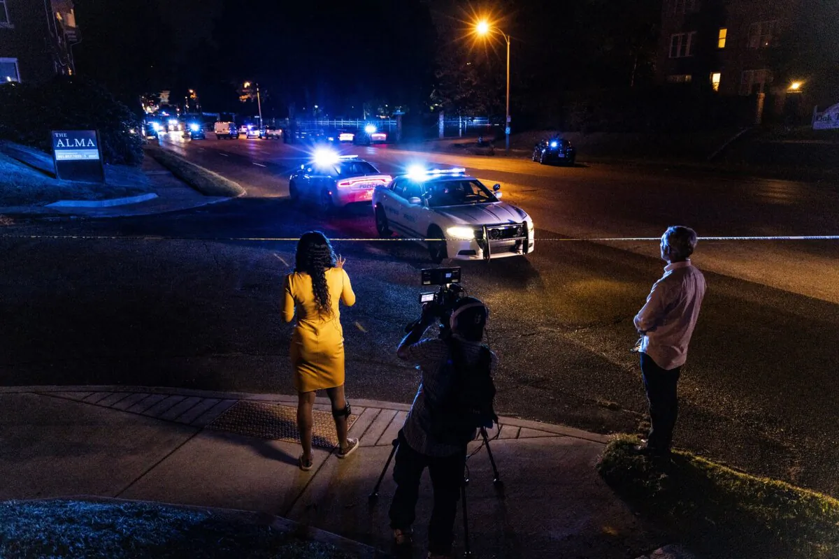 A news crew reports as police investigate the scene of a reported carjacking reportedly connected to a series of shootings in Memphis, Tenn., on Sept. 7, 2022. (Brad Vest/Getty Images)