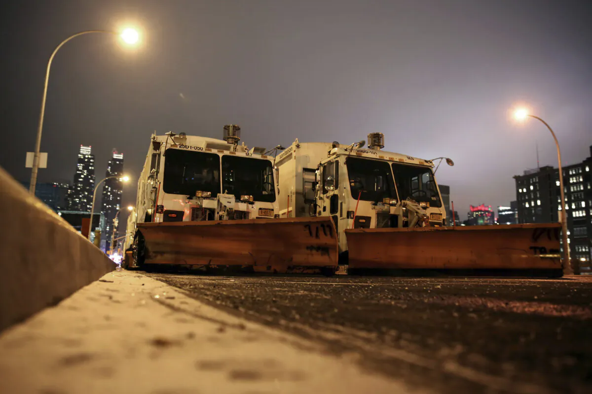 Sanitation trucks mounted with snow plows are parked on the west side of Manhattan in New York on Jan. 2, 2014.  (Peter Morgan/AP Photo)