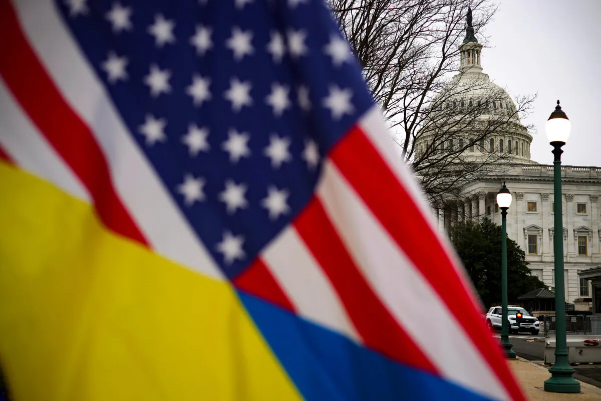 A man holds a mixed flag of Ukraine and America outside the U.S. Capitol in Washington, on Feb. 12, 2024. (Alex Wong/Getty Images)