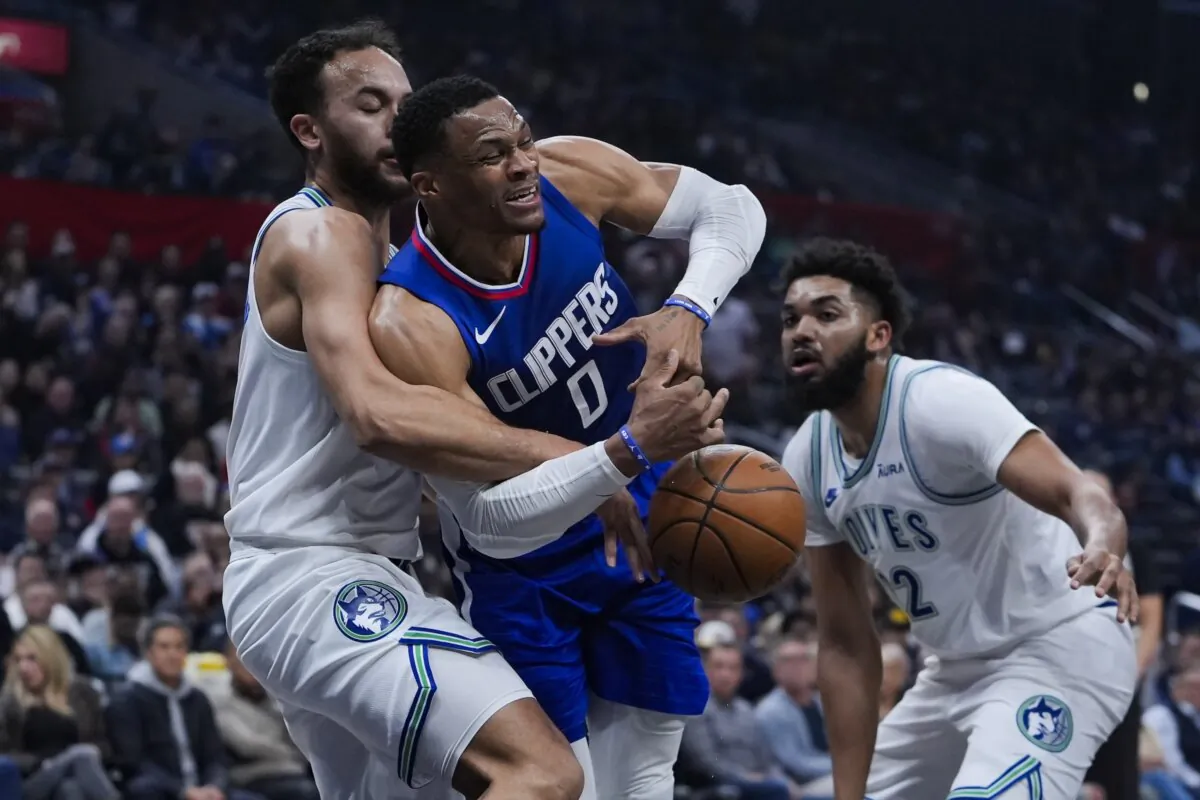 Los Angeles Clippers guard Russell Westbrook (C) attempts to drive past Minnesota Timberwolves forward Kyle Anderson (L) and center Karl-Anthony Towns during the first half of an NBA basketball game in Los Angeles on Feb. 12, 2024. (Ryan Sun/AP Photo)