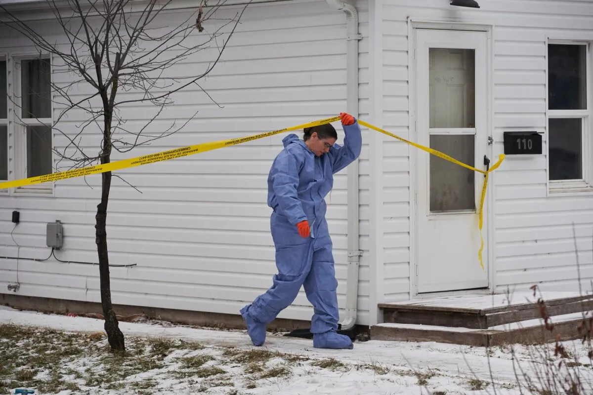 A forensic investigator is on the scene of an ongoing investigation regarding five deaths in southern Manitoba, in Carman, Man., on Feb. 12, 2024. (The Canadian Press/David Lipnowski)