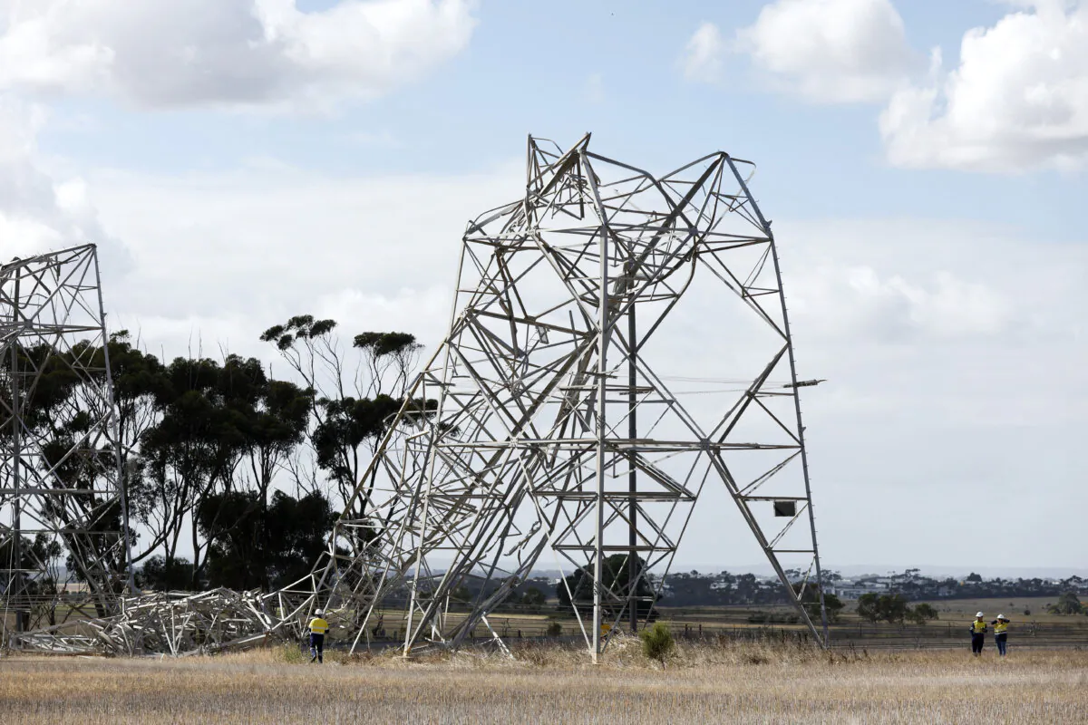 Workers are seen inspecting damaged transmission towers at Anakie in Melbourne, Australia on Feb. 14, 2024.  (AAP Image/Con Chronis) 