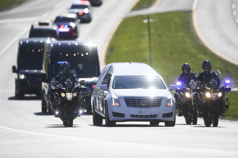 A procession for Greg McCowan, a Blount County sheriff's deputy killed in the line of duty, passes on Alcoa Highway, outside Knoxville, Tenn., on Feb. 13, 2024. (Caitie McMekin/Knoxville News Sentinel via AP)