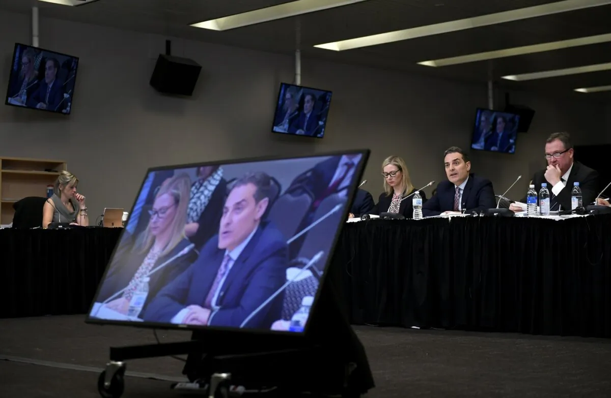 Mirko Bibic, president and CEO of BCE and Bell Canada is seen on television screens as he speaks during a CRTC hearing in Gatineau, Que., on Feb. 19, 2020. (The Canadian Press/Justin Tang)