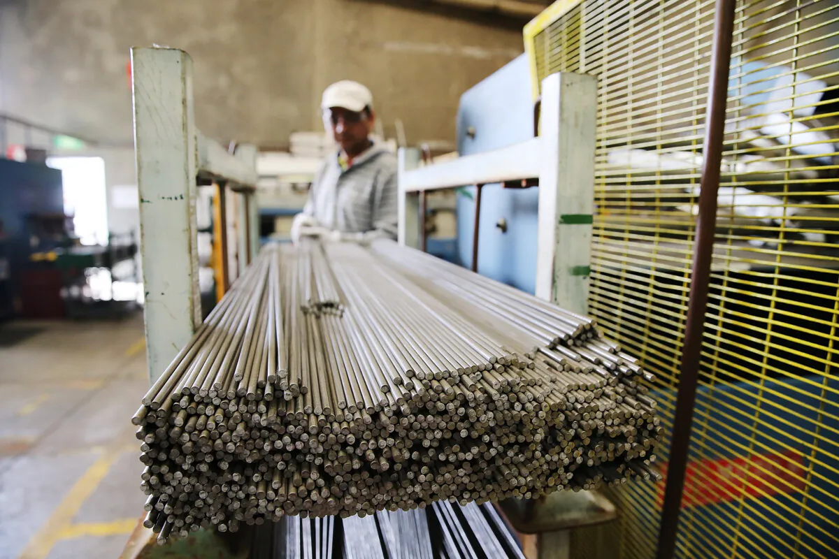 A factory worker moves steel rods at the Multi Slide Industries manufacturing plant in Adelaide, Australia, on Aug. 12, 2013. (Morne de Klerk/Getty Images)