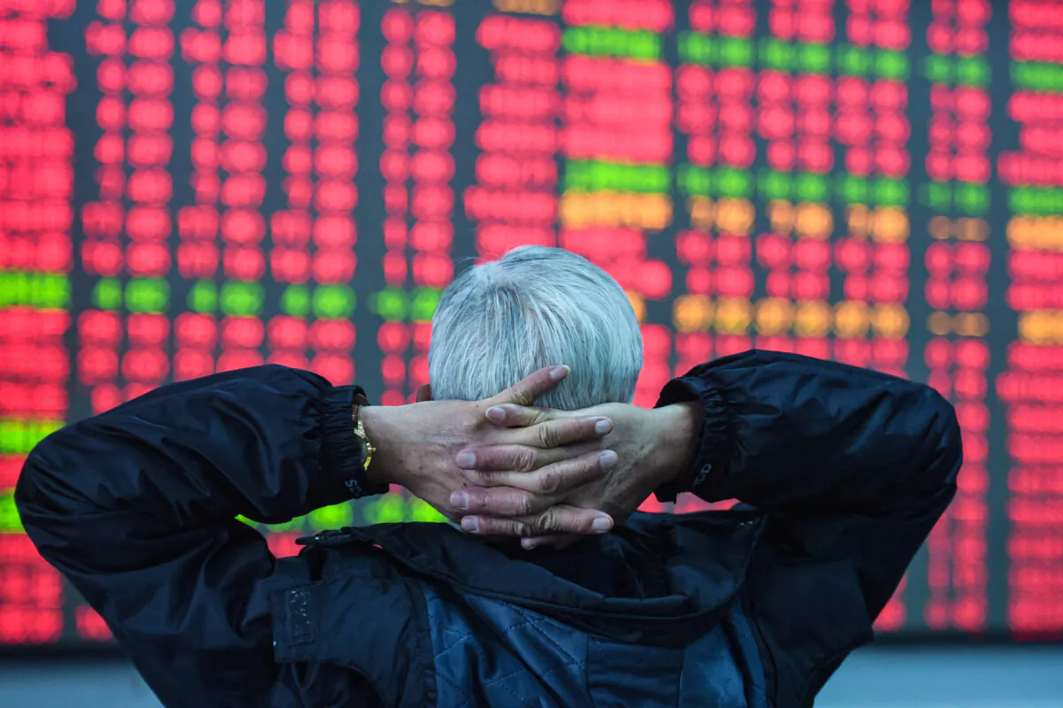 An investor looks at a screen showing stock market movements at a securities company in Hangzhou, in eastern China's Zhejiang Province on Feb. 8, 2024. (STR/AFP via Getty Images)