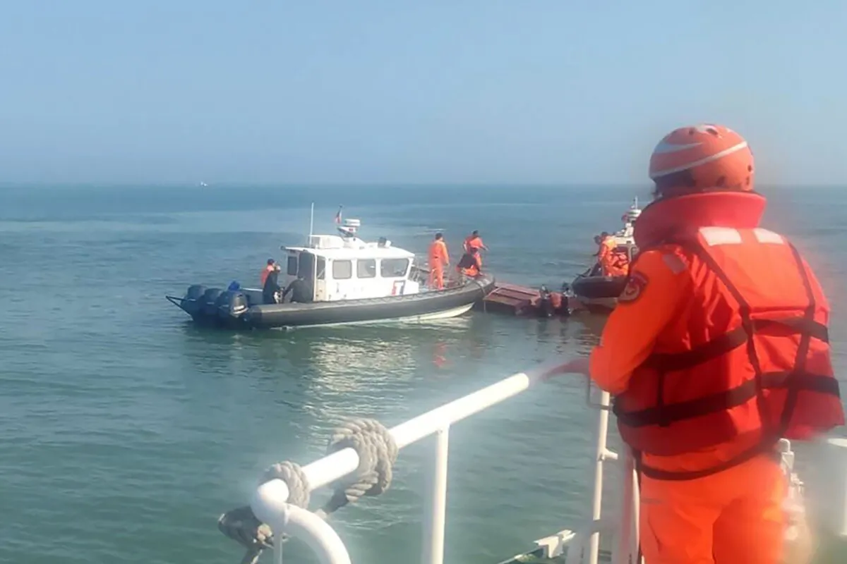 Taiwanese coast guards inspect a vessel that capsized during a chase off the coast of Kinmen archipelago in Taiwan on Feb. 14, 2024. (Taiwan Coast Guard Administration via AP)