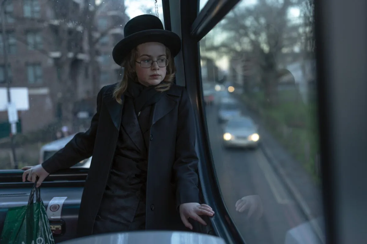 A Jewish boy on the top of an open top bus during the annual Purim holiday, in London, on March 7, 2023. (Dan Kitwood/Getty Images)