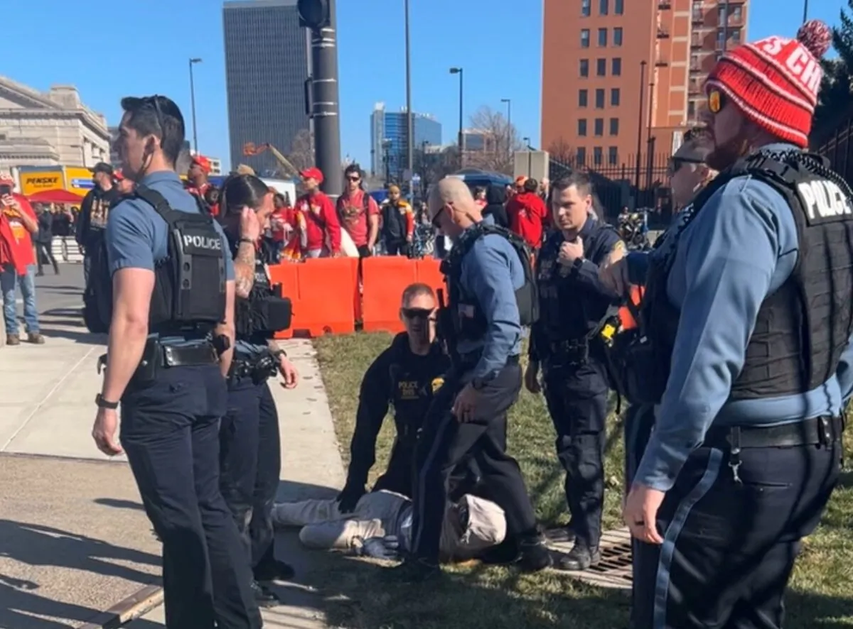 Police officers detain a person outside of Union Station following a shooting near an outdoor celebration of the NFL champion Chiefs' Super Bowl victory, in Kansas City, Mo., on Feb. 14, 2024. (Alyssa Contreras/via Reuters)