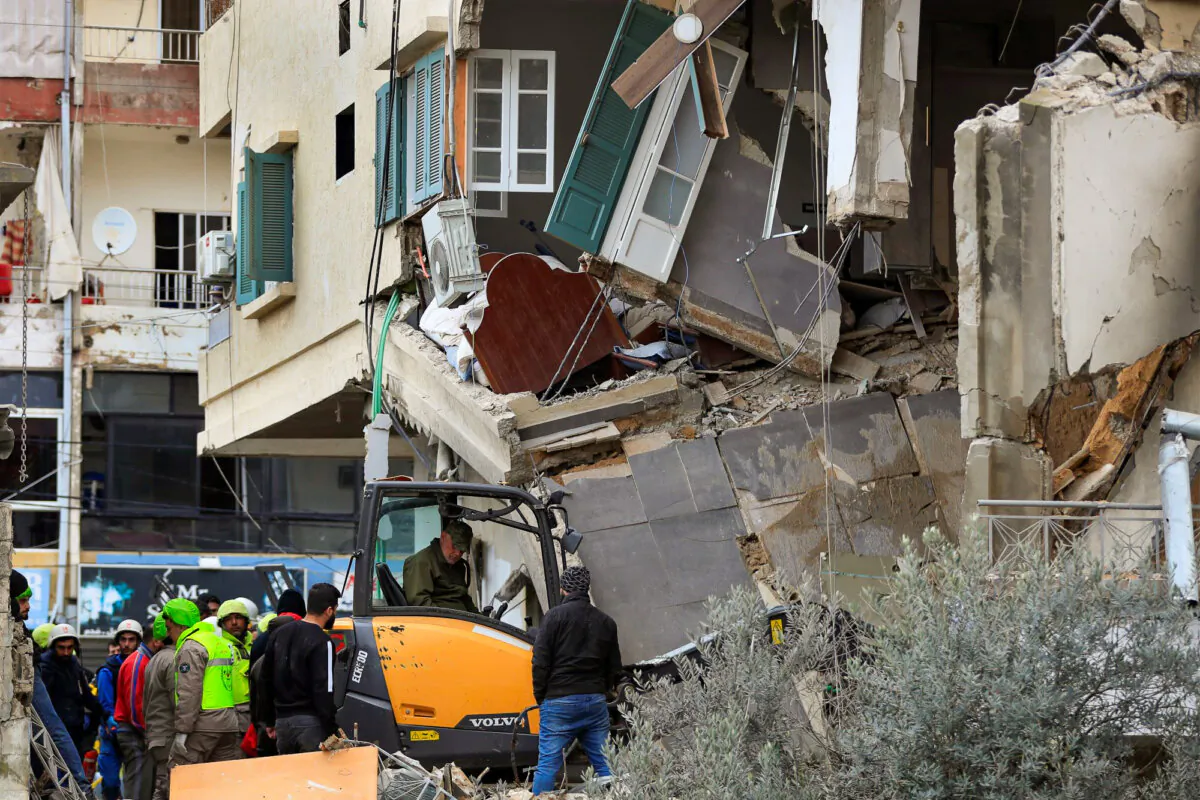 Civil defence and rescue workers remove rubble from a building that was attacked Wednesday night in an Israeli airstrike, in Nabatiyeh, south Lebanon, on Feb. 15, 2024. (Mohammed Zaatari /AP Photo)