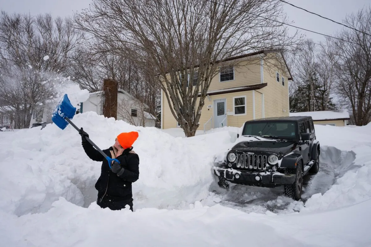 Kat MacIsaac, a nurse at the Cape Breton Regional Hospital's dialysis unit, shovels out her driveway in Sydney, N.S., on Feb. 14, 2024. (The Canadian Press/Steve Wadden)