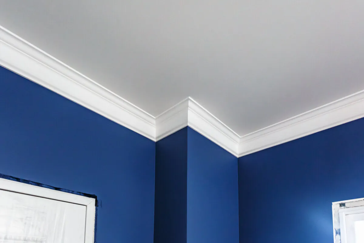 To make the cut on the proper angle, you should cut the molding upside-down and backward with the miter saw. This will give you the proper 45-degree angles on the mating edges of the two pieces in the corners. (jantsarik/Shutterstock)