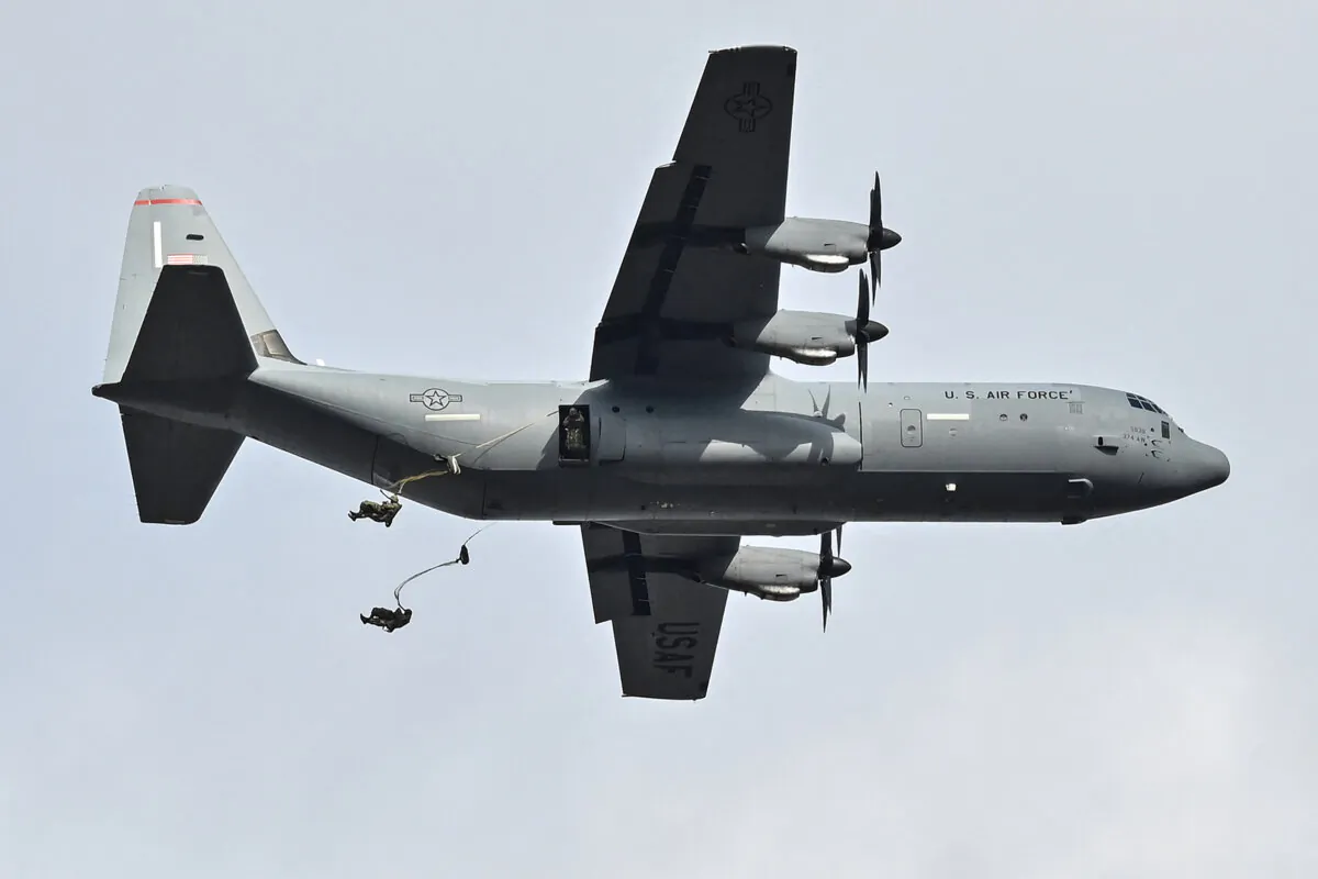Military personnel jump from a U.S. Air Force plane as they take part in a joint military drill and demonstration conducted by Japan's Ground Self-Defence Force 1st Airborne Brigade with participants from the U.S., Britain, Canada, Germany, and others at Camp Narashino in the city of Funabashi, Chiba prefecture, east of Tokyo, on Jan. 7, 2024. (Richard A. Brooks/AFP via Getty Images)