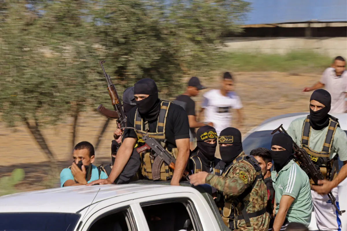 Hamas terrorists move toward the border fence with Israel from Khan Yunis in the southern Gaza Strip on Oct. 7, 2023. (Said Khatib/AFP via Getty Images)
