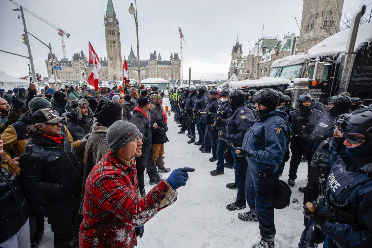 Police move in to clear downtown Ottawa near Parliament Hill of protesters after weeks of demonstrations on Feb. 19, 2022. (The Canadian Press/Cole Burston
