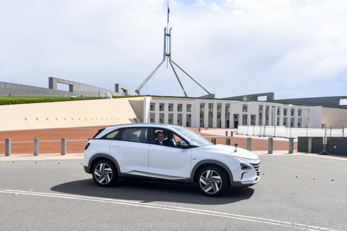 Leader of the Opposition Anthony Albanese drives a Hyundai Nexo hydrogen powered vehicle past Parliament House in Canberra, Dec. 1, 2021. (AAP Image/Mick Tsikas)