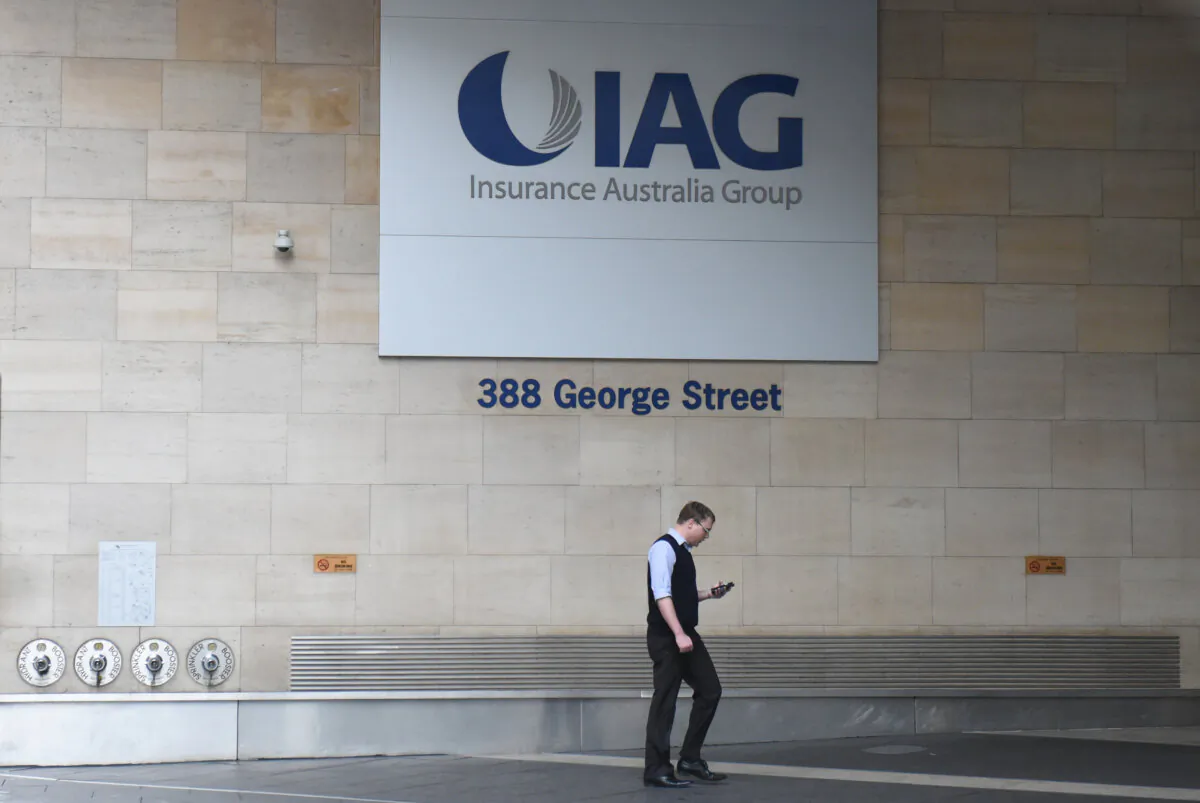 A man walks past the Insurance Australia Group head office in Sydney, July 13, 2015.  (AAP Image/Mick Tsikas)