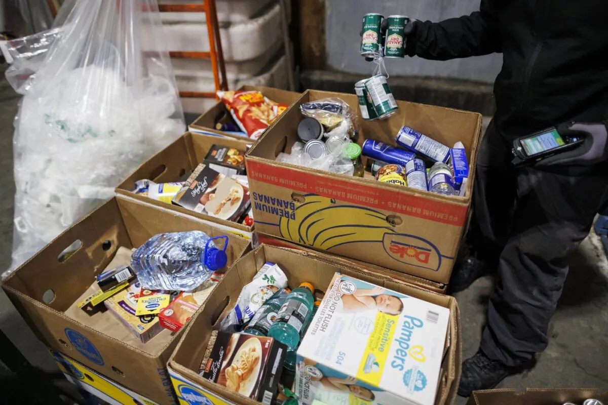 Food and goods are sorted to be sent to a food bank at a Metro grocery store In Toronto on Feb. 2, 2024. (The Canadian Press/Cole Burston)