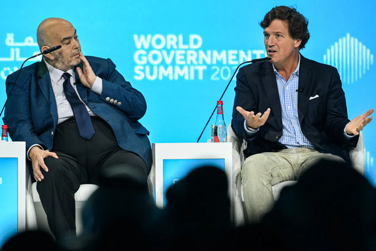 Tucker Carlson (R), U.S. television personality and founder of the Tucker Carlson Network, speaks at a panel session with Egyptian television personality and businessman Emad el-Din Adib during the World Government Summit in Dubai on Feb. 12, 2024. (Ryan Lim/AFP via Getty Images)