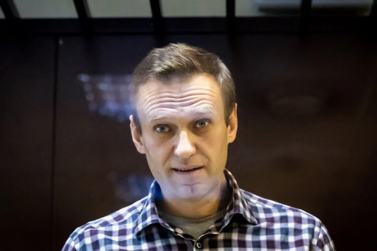 Russian opposition leader Alexei Navalny looks at photographers from inside a glass cage in the Babuskinsky District Court in Moscow on Feb. 20, 2021. (Alexander Zemlianichenko/AP Photo)