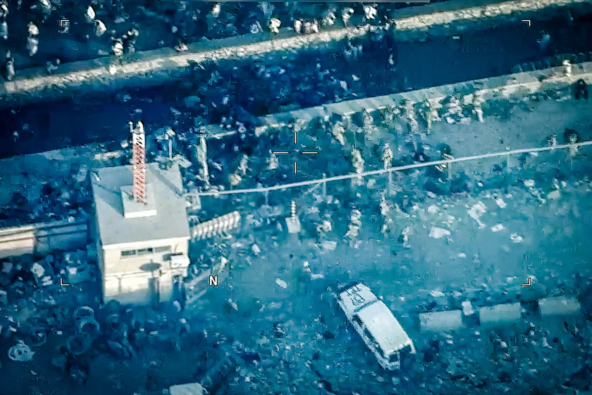 This image from a video released by the Department of Defense shows U.S. Marines around the scene at Abbey Gate outside Hamid Karzai International Airport on Aug. 26, 2021, in Kabul Afghanistan, after a suicide bomber detonated an explosion. The military investigation into the deadly attack during the Afghanistan evacuation has concluded that a suicide bomber, carrying 20 pounds of explosives packed with ball bearings, acted alone, and that the deaths of more than 170 Afghans and 13 U.S. service members were not preventable. (Department of Defense via AP)