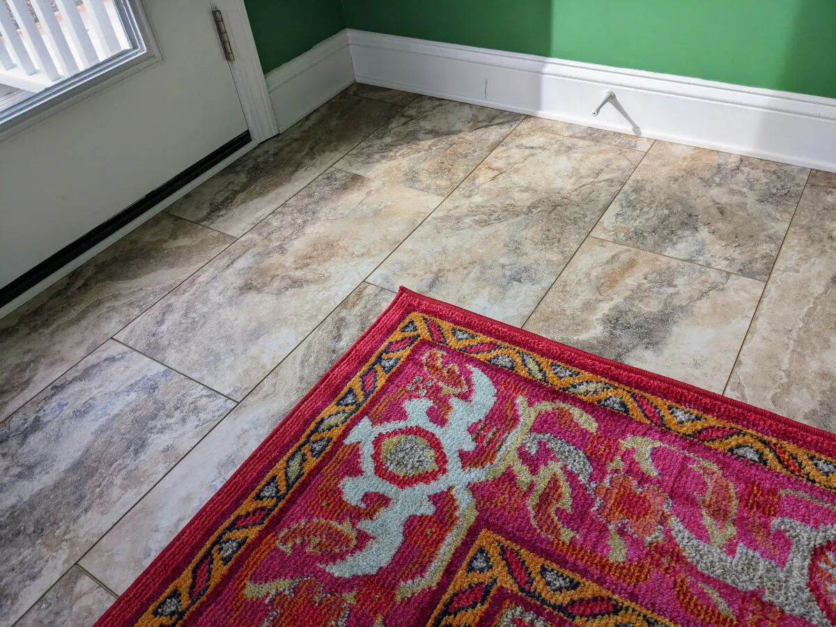 This is a new luxury vinyl plank floor that looks like travertine stone. The area rug adds a delightful splash of color and helps to absorb sound. Don’t be afraid to introduce bold colors or patterns. (Tim Carter/Tribune Content Agency)