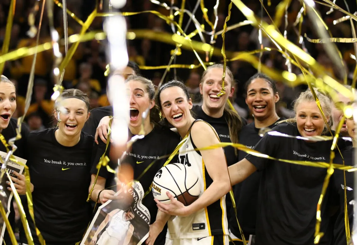 Guard Caitlin Clark (22) of the Iowa Hawkeyes celebrates with teammates during a presentation after breaking the NCAA women's all-time scoring record during the game against the Michigan Wolverines  at Carver-Hawkeye Arena in Iowa City, Iowa, on Feb. 15, 2024.  (Matthew Holst/Getty Images)