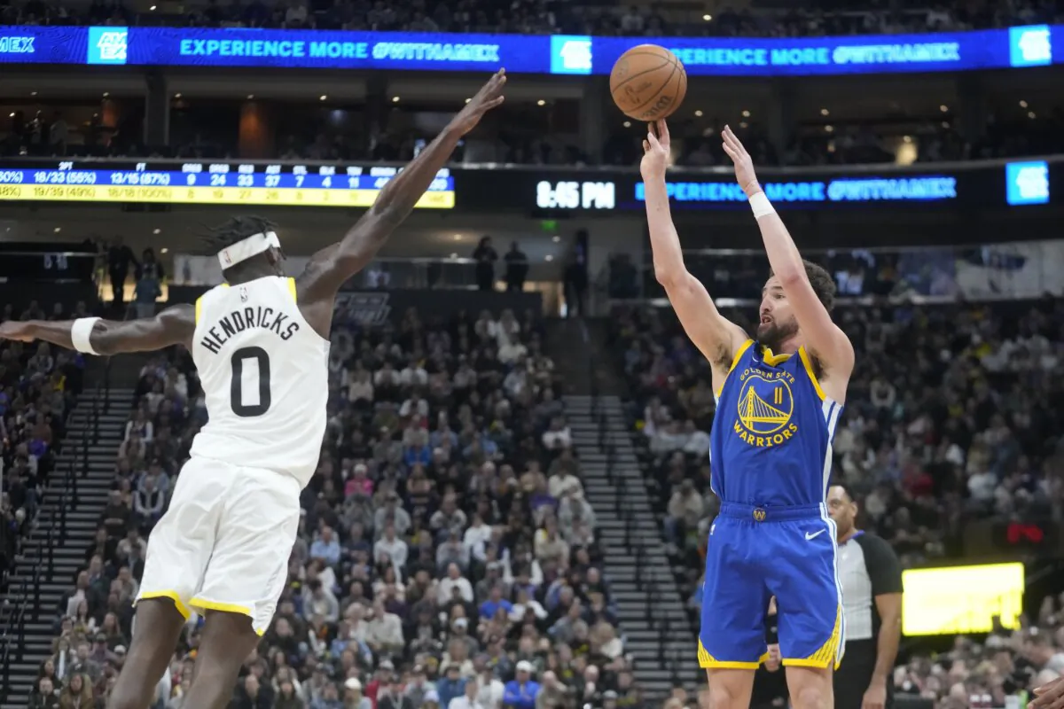 Golden State Warriors guard Klay Thompson (11) shoots a 3-point basket against Utah Jazz forward Taylor Hendricks (0) during the second half of an NBA basketball game in Salt Lake City on Feb. 15, 2024. (Rick Bowmer/AP Photo)