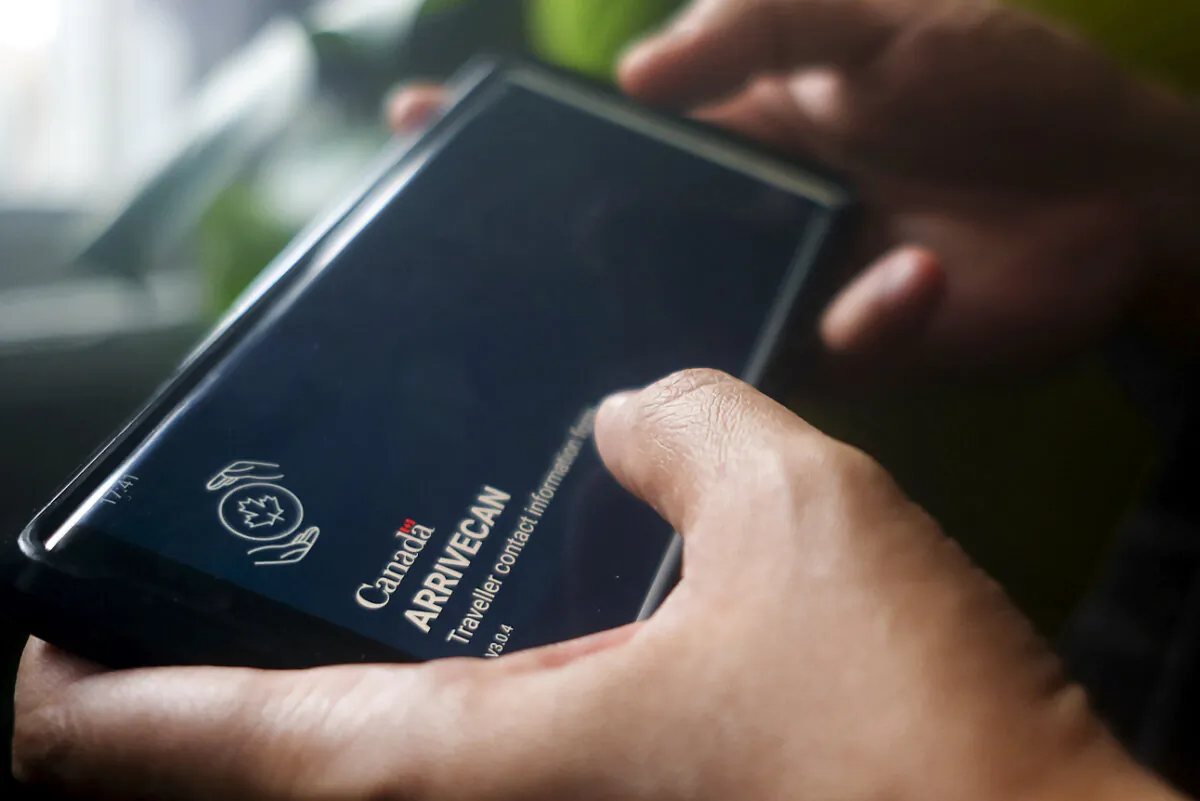 A smartphone set to the opening screen of the ArriveCan app is seen in a file photo. (The Canadian Press/Giordano Ciampini)