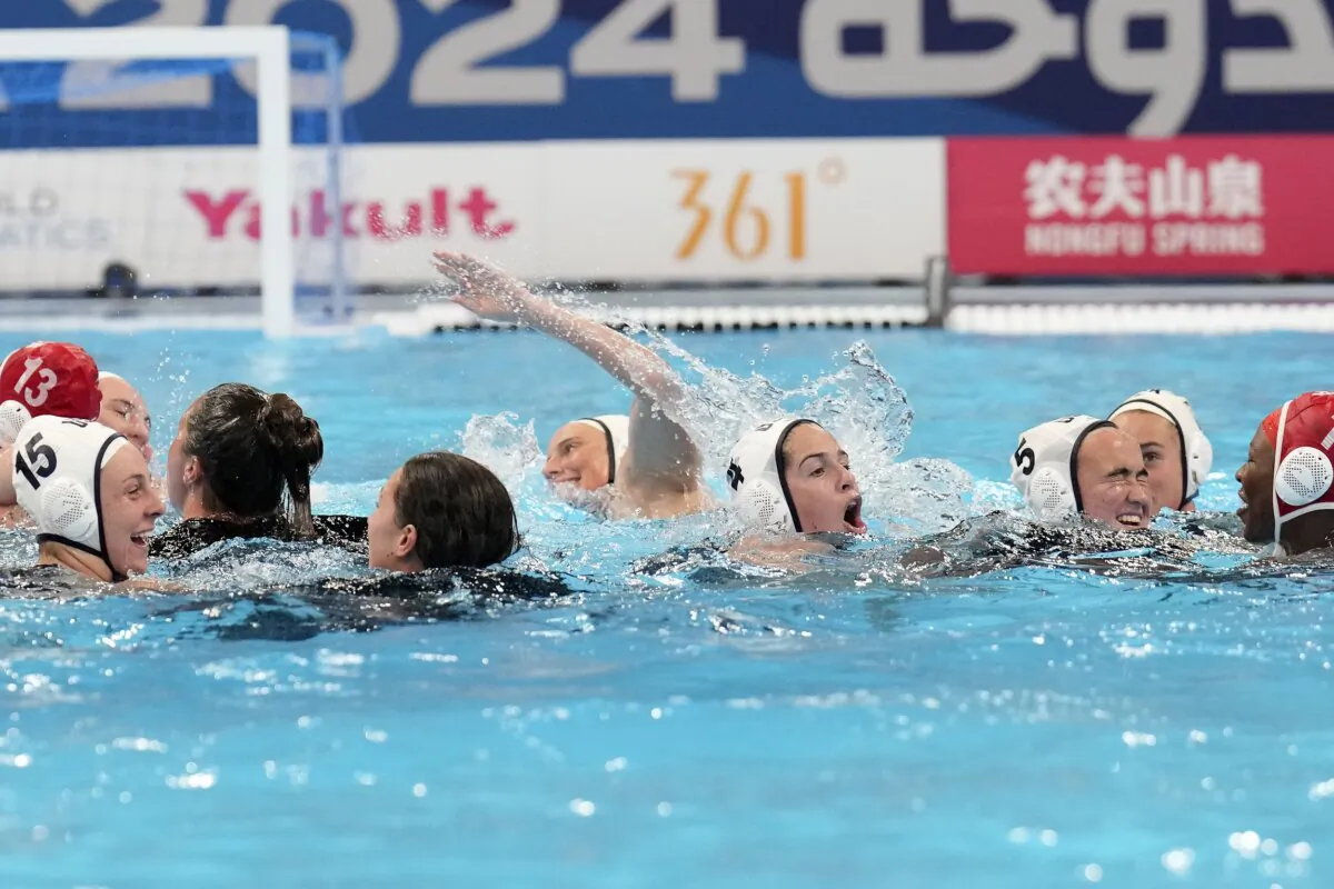 Players from the United States celebrate their victory over Hungary during the women's water polo final at the World Aquatics Championships in Doha, Qatar, on Feb. 16, 2024. (Lee Jin-man/AP Photo)