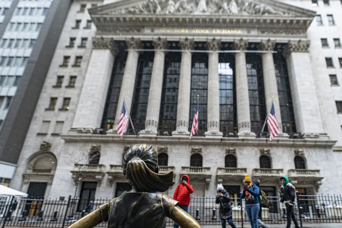 People photograph the Fearless Girl statue outside the New York Stock Exchange in New York on Jan. 19, 2024. (Peter K. Afriyie/AP Photo)
