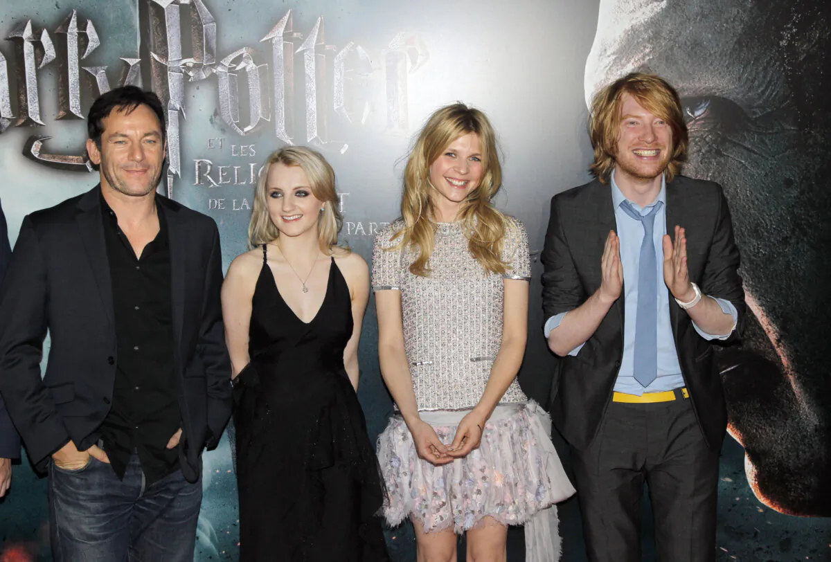 Cast members of the film 'Harry Potter and the Deathly Hallows Part 2' pose upon arrival for a screening in Paris on July 12, 2011. From L: British actor Jason Isaacs, Irish actress Evanna Lynch, French actress Clémence Poésy, and Irish actor Domhnall Gleeson. (Patrick Kovarik/AFP via Getty Images)