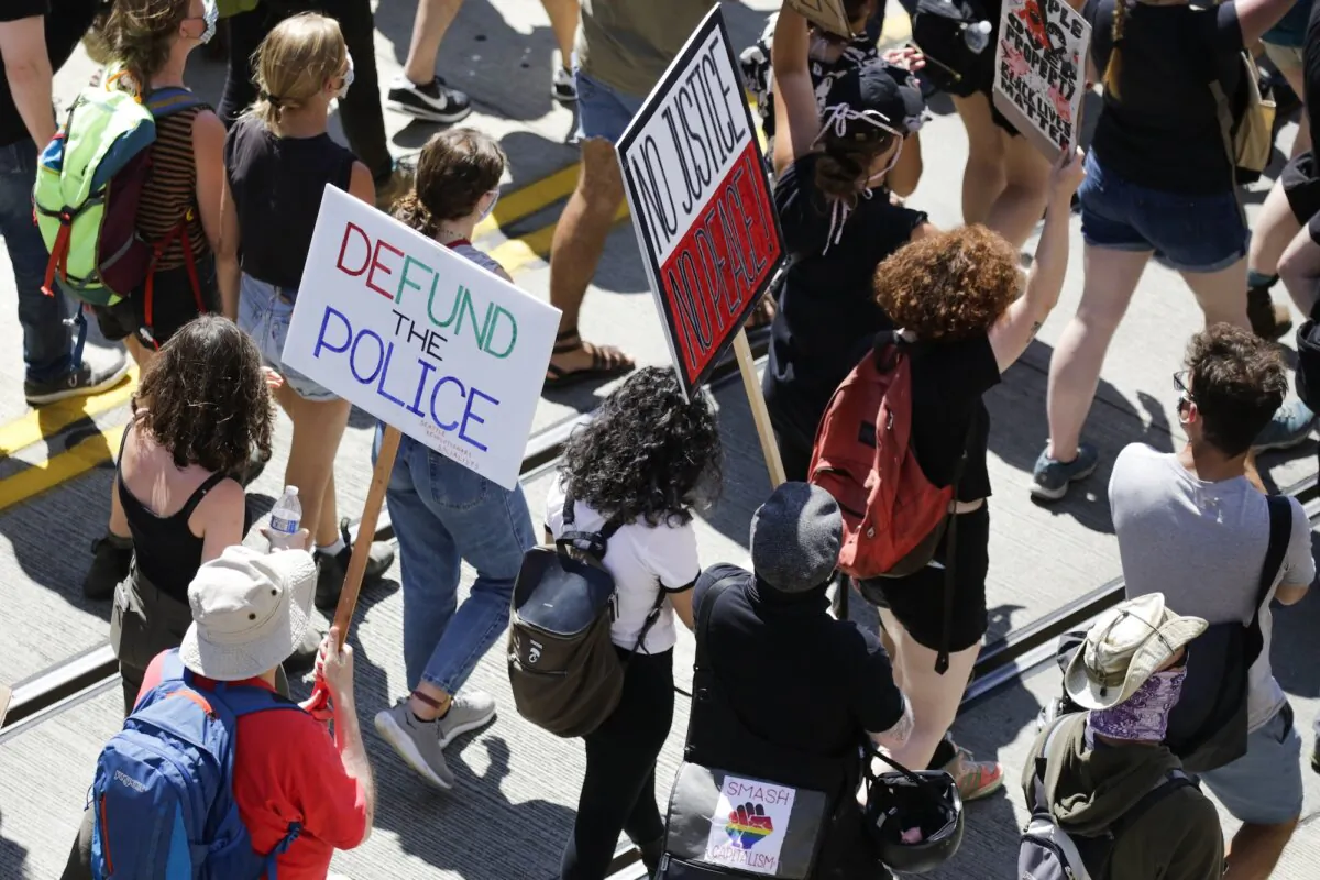 People carry signs during a "Defund the Police" march in Seattle, Washington, on Aug. 5, 2020. (Jason Redmond/AFP/Getty Images)