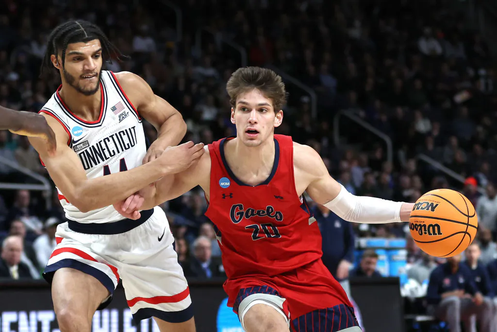 Aidan Mahaney (20) of the St. Mary's Gaels handles the ball against Andre Jackson Jr. (44) of the Connecticut Huskies in the first half during the second round of the NCAA Men's Basketball Tournament at MVP Arena in Albany, N.Y., on March 19, 2023. (Patrick Smith/Getty Images)