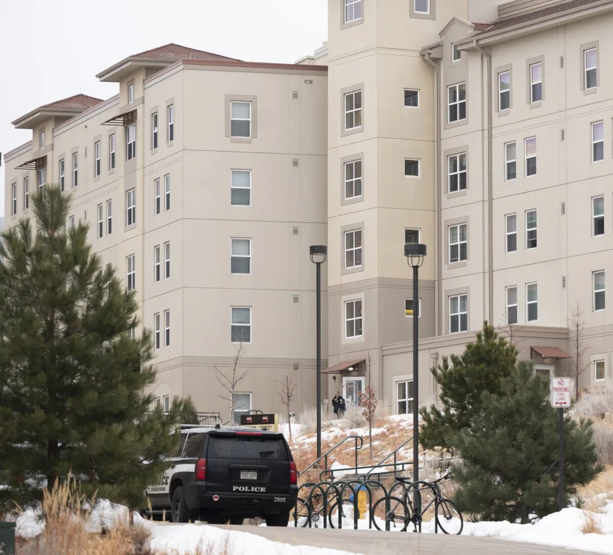 A police officer stands outside a dorm in the Village at Alpine Valley housing, Colo., on Feb. 16, 2024. (Christian Murdock/The Gazette via AP)