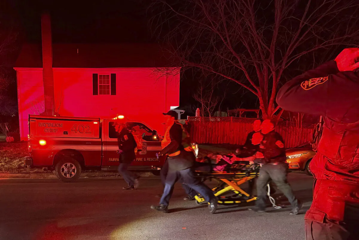 First responders carry an injured person away after an explosion at a home, in Sterling, Va., on Feb. 16, 2024. (Nicki Jhabvala/The Washington Post via AP)