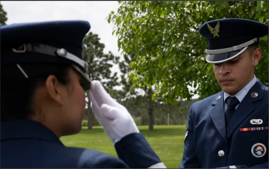 Airman 1st Class Mialani Mae Morgan, 28th Force Support Squadron ceremonial guardsman, salutes a flag at Black Hills National Cemetery, S. Dakota, on June 1, 2023. (Airman 1st Class Yendi Borjas, U.S. Air Force)