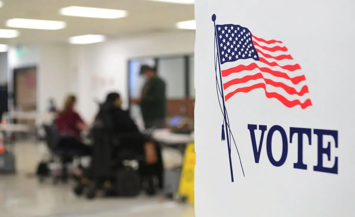 People check in before casting their vote at the Los Angeles County Registrar's Office in Norwalk, Calif., on Sept. 14, 2021. (Frederic J. Brown/AFP via Getty Images)