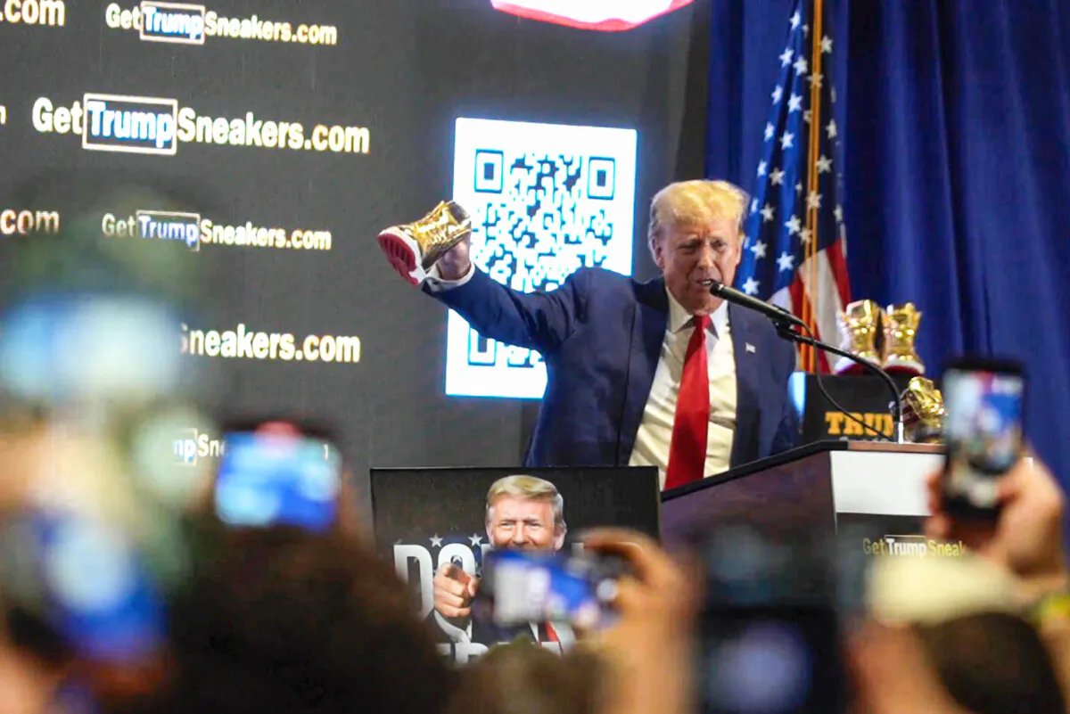 Republican presidential candidate and former President Donald Trump held up his own new sneaker and spoke at Sneaker Con in Philadelphia, Pa., on Feb. 17, 2024. (William Huang/The Epoch Times)