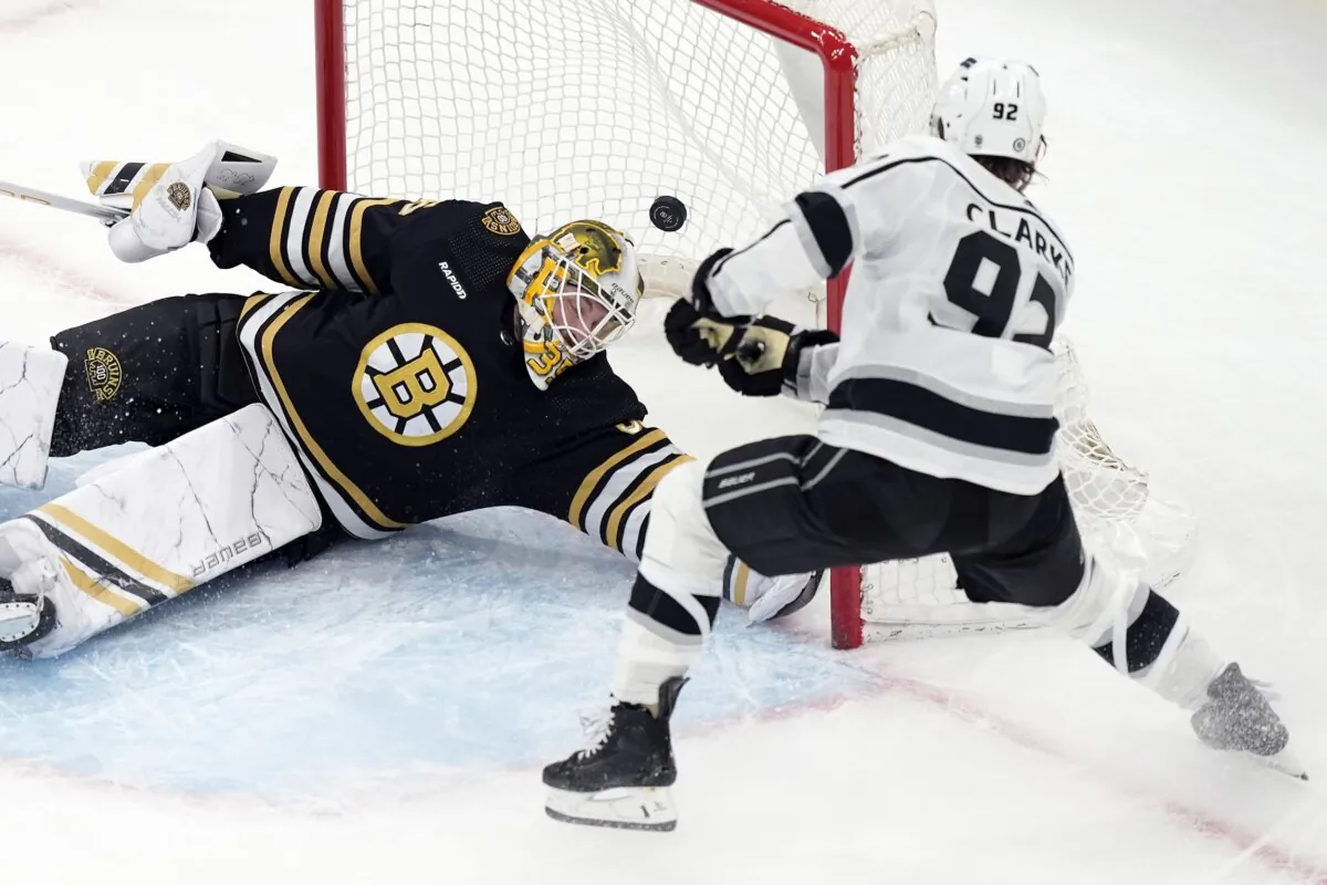 Los Angeles Kings' Brandt Clarke (92) scores past Boston Bruins' Linus Ullmark (35) during overtime in an NHL hockey game in Boston on Feb. 17, 2024. (Michael Dwyer/AP Photo)